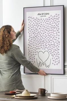 a woman is holding up a poster with writing on it