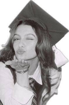 black and white photograph of a woman wearing a graduation cap with her hand on her mouth