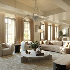 a living room filled with lots of furniture next to tall windows and curtains on the walls