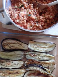 an assortment of food is being prepared in a pan on a table with utensils