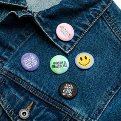 four badges on a denim jacket that say, attention is health - care's