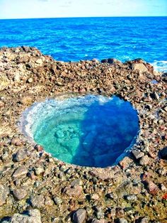 a blue hole in the rocks by the ocean