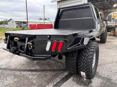 the back end of a truck parked in front of a building