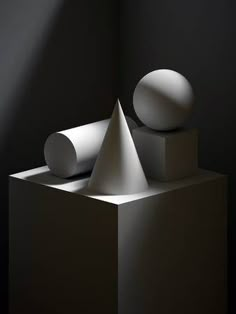 a white object sitting on top of a block of concrete in the dark room with light coming through it