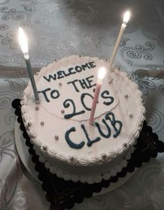 a birthday cake with two candles on it and the words welcome to the log's club