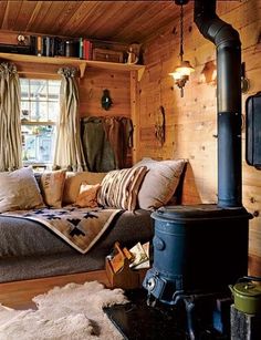 a living room filled with furniture and a wood stove