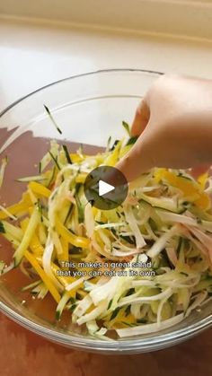 someone is sprinkling shredded cheese into a bowl