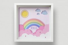 a white frame with a rainbow and clouds on it