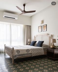 a bedroom with a bed and ceiling fan