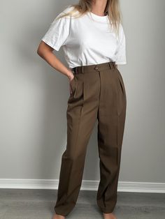 Vintage | Deadstock Liz Claiborne trousers from the 80s. Color is somewhere around an olive drab / brown. Tag still attached. Fabric: 100% wool Vintage Size: 12 Measurements taken flat: waist 14.5" + hips 23" + rise 13" + inseam 30.5" Model specs: medium frame + height 5'7" + bust 36" + waist 29" + hips 40" All vintage items are preloved and due to their delicate nature, subtle flaws and natural signs of wear are to be expected. Please be gentle & treat with care. Reach out with any questions, all sales are final. High Waist Olive Pants For Work, High Waist Khaki Dress Pants For Work, High-waisted Olive Pants For Work, Classic High Waist Brown Pants, High Waist Olive Bottoms For Work, Classic Olive Pants With Pockets, Classic Khaki Bottoms For Fall, Vintage Workwear Pants For Fall, Vintage Fall Workwear Pants