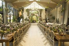 an indoor wedding venue with tables and chairs set up for a formal dinner or reception