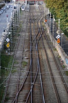 an overhead view of train tracks and traffic signs