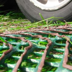 the tire of a car is parked on some grass