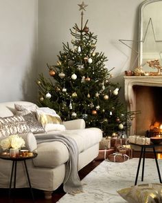 a living room with a christmas tree in the corner