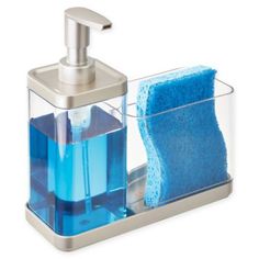 a soap dispenser with a blue towel in it and a silver holder