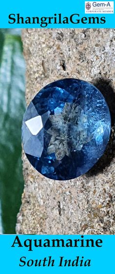 an aquamarine blue stone sitting on top of a rock