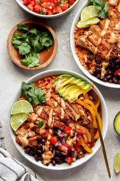 three bowls filled with chicken, black beans and avocado on top of a table