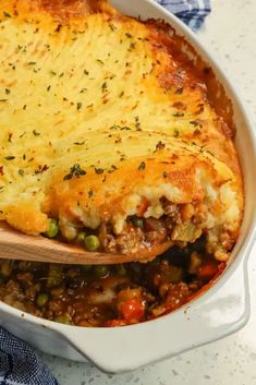 a casserole dish filled with meat and vegetables