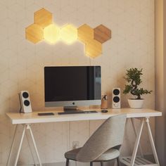 a computer monitor sitting on top of a white desk next to a keyboard and mouse