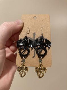 4th Wing inspired Earrings  Type A is Both gold and Black on each ear Type B is Gold on one ear Black on the other Message me when you order if you need Surgical steel hooks! Themed Black Metal Jewelry, Themed Black Dangle Jewelry, Themed Black Jewelry As Gift, Themed Black Jewelry Gift, Nickel Free Themed Black Jewelry, Themed Black Dangle Earrings, Gift Black Metal Cartilage Earrings, Themed Gold Earrings For Gifts, Black Dangle Plug Earrings As Gift