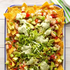 a platter filled with nachos and guacamole