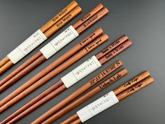 six wooden chopsticks with writing on them