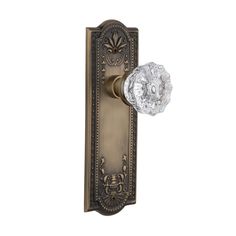 an antique style door handle with glass knob