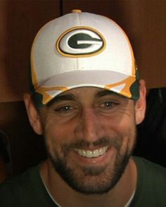 a man wearing a green bay packers hat