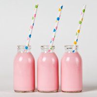 three jars with straws in them are lined up