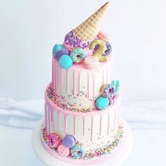 a three tiered cake with ice cream and sprinkles