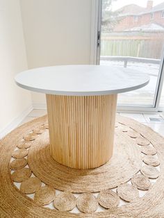 a round table sitting on top of a rug