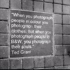 a brick wall with a sign on it that says when you photograph people in color you photography their clothes