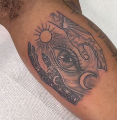 a close up of a person's arm with an eye and hand tattoo on it