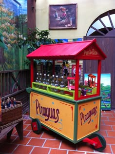 a small vending machine with many bottles on it