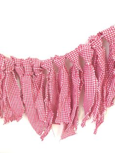 a red and white checkered fabric hanging on a wall