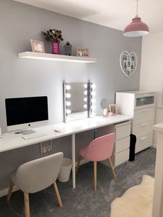 a white desk with two chairs and a computer on it in front of a mirror