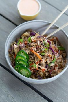 a white bowl filled with rice and veggies