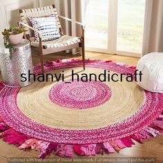 a pink and white rug with fringes on the floor in front of a window