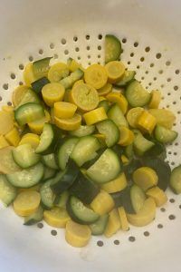 the cucumbers are cut up and ready to be cooked in the colander