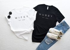 two t - shirts with the words wife and husband printed on them next to ripped jeans