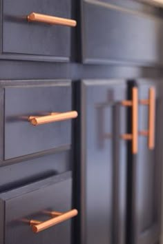 the drawers are painted black with copper handles