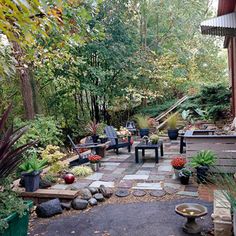 an outdoor patio with chairs and tables surrounded by trees