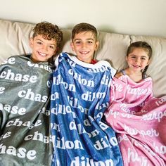 three children wrapped up in blankets on a bed with the words chase printed all over them