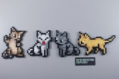 four pixelated animals are sitting next to each other on a gray surface with a black and white sticker