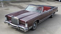 a brown car parked on top of a parking lot