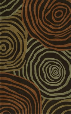 an area rug with different colored circles on the ground and black, brown, green, and tan colors