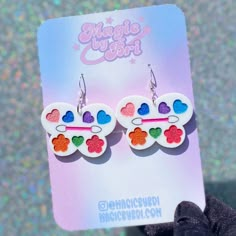 a pair of earrings with hearts on them