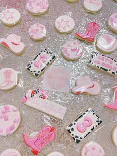 some decorated cookies on a table with pink icing