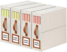 three white boxes with sticky notes and colored pencils in each one's compartment