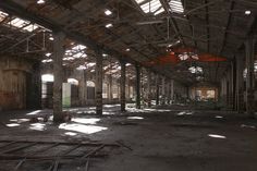 an abandoned building with lots of windows and debris